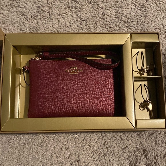 Coach Handbags - Coach Sparkly Maroon Wristlet with Goldtone charms